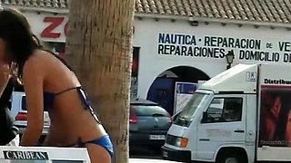 Street voyeur finds a busty brunette in a sexy blue bikini