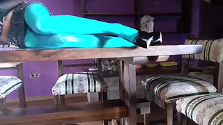 MILF with Beautiful Legs in Pantyhose and Heels Lying on the Table