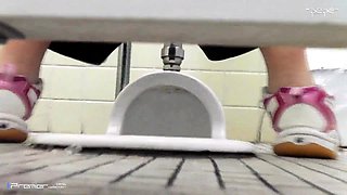 Toilet voyeur spying on a lovely Japanese babe pissing