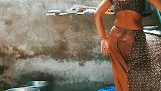In the country&#039;s bathroom of the village, the elder sister-in-law&#039;s stepsister is soaking her saree in water and bathi