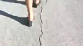 Mel walking on the side of the road