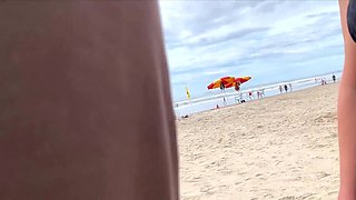 Milf holds my penis tightly in her hand until I cum right on the beach