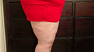 Beautiful social media model in mini red dress and high heels showing off