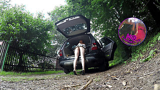 Hot redhead in short skirt loads a car
