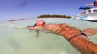topless russian swimming in tropical sea