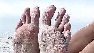 Milf seductress showing off her fabulous feet outdoors