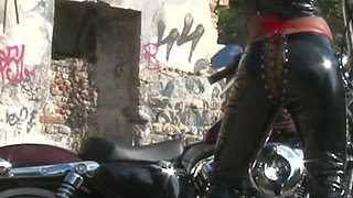 Outstanding brunette teasing outdoors by the chopper