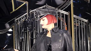 Mistress Tokyo Smoking Cigarette In Leather, Gloves And Muir Cap