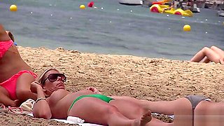 Hot MILF with huge tits on topless beach