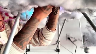 Pierced and tattooed boy sucking black cock from glory hole