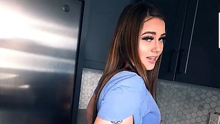 Tattooed amateur doll leans on kitchen counter