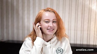 Ginger in white hoodie talks to camera