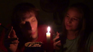 Couple Smoke Next to Candle