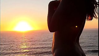 Buxom babe shows off sexy body in nude poses at sunset