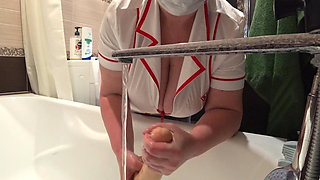 Big Boobs. Gorgeous Cleavage Under a Medical Gown. a Mature Nurse on Camera at Work