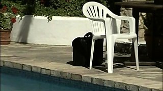 In a kitchen a sexy brunette playing with her big boobs