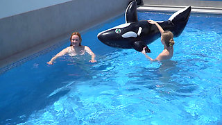 Lesbian Girls Are Having Fun in a Pool with an Inflatable Shark