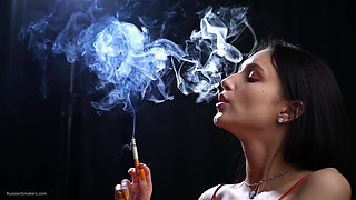 Sexy Lady in Red Is Smoking Two 100mm Reds