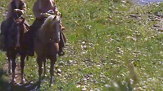 Two towheaded damsels in high high-heeled shoes sit on a