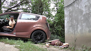 Mistress Jenna Stands on the Slave with a Car While Smoking in the Slave's Mouth